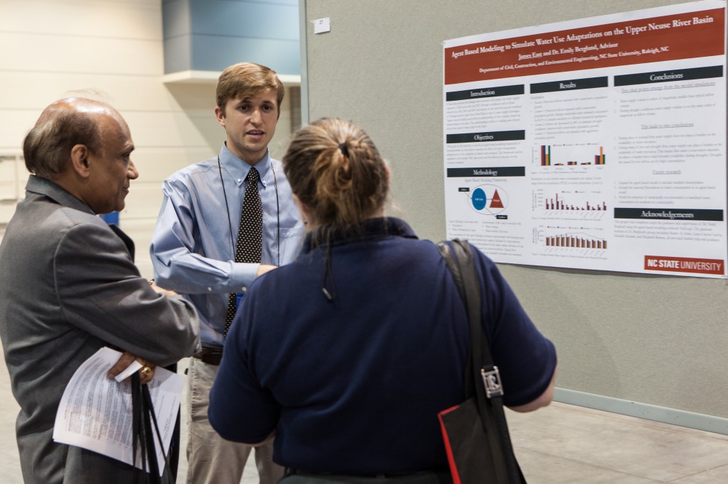 James East (center) presents his poster to Dr. Ashok Kumar (left) of the University of Toledo and Dr. Pam Heckel (right).
