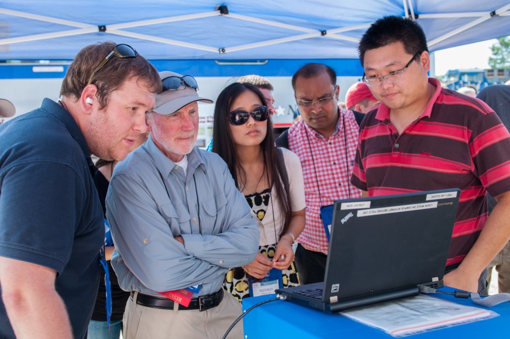 Attendees view locomotive emissions data as explained by PhD student Jiangchuan Hu (right).